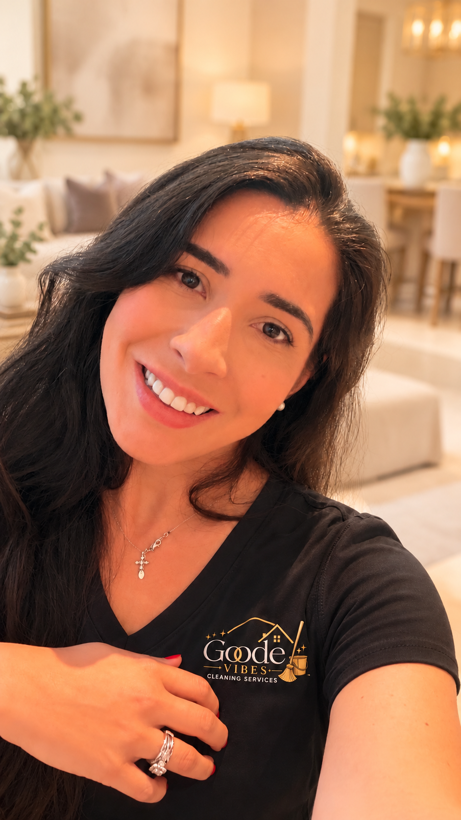 Gabi, founder of Goode Vibes Cleaning, wearing her black and gold uniform